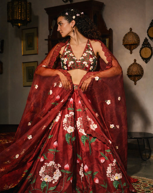 Woman wearing a red floral embroidered traditional outfit in an indoor setting.

Designer lehenga sets online shopping
Hand-embroidered lehenga for weddings
Luxury lehenga online India
Designer skirt sets with jacket
Lehenga with cape sets
Pre-draped lehenga sets
Mirror work lehenga
Organic fabric lehenga
Minimalist designer lehenga
Luxury lehenga Delhi Khan Market
